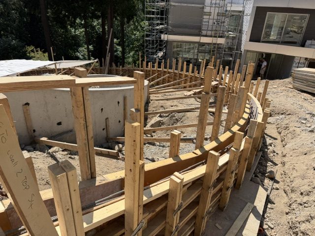 Curved plywood formwork bending along the radius for a cast-in-place architectural concrete wall, West Vancouver