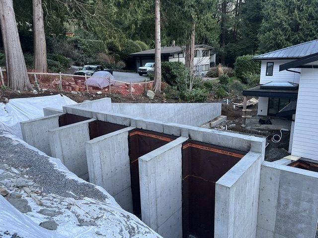 Cast-in-place buttressed (counterfort) concrete retaining walls with waterproofing membrane, West Vancouver
